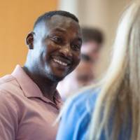 Man in conversation with event guest who is facing away from camera